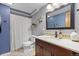 Cozy bathroom with a vanity, commode, mirror, and tiled backsplash on the counter at 8544 S Upham Way, Littleton, CO 80128