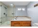 Bathroom with an enclosed shower, soaking tub and plant near the window offering a refreshing ambiance at 8544 S Upham Way, Littleton, CO 80128