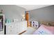 This bedroom includes a dresser and storage creating a fun and organized space at 8544 S Upham Way, Littleton, CO 80128
