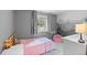Cozy bedroom includes mountain mural, window, toy and plush seat, perfect for imaginative play at 8544 S Upham Way, Littleton, CO 80128