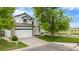 Charming two-story home with a spacious driveway, two car garage and manicured lawn at 8544 S Upham Way, Littleton, CO 80128
