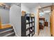 Hallway with stairs leading up to the bedroom with light wood flooring and gray walls at 8544 S Upham Way, Littleton, CO 80128