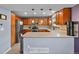 Well-equipped kitchen featuring stainless steel appliances, ample counter space, and stylish pendant lighting at 8544 S Upham Way, Littleton, CO 80128
