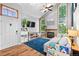 Bright living room boasts vaulted ceilings, skylights, a stone fireplace, and expansive windows for natural light at 8544 S Upham Way, Littleton, CO 80128