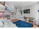 Inviting living room features an open staircase, wood flooring, and ample natural light at 8544 S Upham Way, Littleton, CO 80128