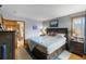 Comfortable bedroom offers wood floors, dresser and view into the bathroom, adding convenience at 8544 S Upham Way, Littleton, CO 80128