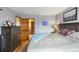 Relaxing bedroom features hardwood floors, a gray color scheme and convenient access to bathroom at 8544 S Upham Way, Littleton, CO 80128