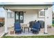 Covered outdoor patio with blue chairs, table, and grill at 8544 S Upham Way, Littleton, CO 80128