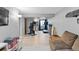 Home gym with exercise machines, a TV, gray walls and light-colored flooring at 8544 S Upham Way, Littleton, CO 80128