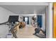 Workout room area showcasing exercise equipment leading into a living room space at 8544 S Upham Way, Littleton, CO 80128