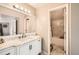 Updated bathroom with marble countertops, a modern vanity, and a shower over tub at 10872 W Evans Ave # 3D, Lakewood, CO 80227