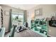 Bright bedroom with a scenic view, bookshelf, desk, and excercise bike at 10872 W Evans Ave # 3D, Lakewood, CO 80227