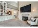 Open-concept living area features a fireplace, spiral staircase, and breakfast bar leading to the kitchen at 10872 W Evans Ave # 3D, Lakewood, CO 80227