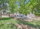 Spacious backyard featuring mature trees, a grassy lawn, a privacy fence, and an outdoor seating area at 12653 Jersey E Cir, Thornton, CO 80602