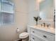 Bright half bathroom featuring a modern vanity, updated fixtures, and fresh paint at 12653 Jersey E Cir, Thornton, CO 80602