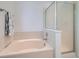 Well-maintained bathroom featuring a shower with glass door, bathtub, and neutral color scheme at 12653 Jersey E Cir, Thornton, CO 80602