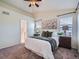 Comfortable bedroom featuring a carpet flooring, ensuite bathroom, and generous natural light at 12653 Jersey E Cir, Thornton, CO 80602