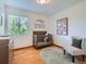 Cozy Bedroom with a wooden crib, patterned rug, and a comfortable chair near the window at 12653 Jersey E Cir, Thornton, CO 80602