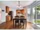 Eat-in kitchen with wood cabinets, stainless appliances, and sliding glass door to the backyard at 12653 Jersey E Cir, Thornton, CO 80602