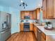 Efficient kitchen featuring stainless steel appliances, wooden cabinets, and a clean, functional layout at 12653 Jersey E Cir, Thornton, CO 80602