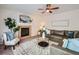 Cozy living room featuring a fireplace, stylish furnishings, and ample natural light at 12653 Jersey E Cir, Thornton, CO 80602