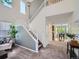 Elegant open-concept living room with staircase, leading to the dining area and providing lots of natural light at 12653 Jersey E Cir, Thornton, CO 80602