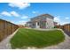 Expansive backyard with lush lawn, mature landscaping, and a privacy fence for outdoor enjoyment at 87 Green Fee Cir, Castle Pines, CO 80108