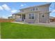 Well-maintained backyard featuring lush green grass, a concrete patio, and privacy fencing at 87 Green Fee Cir, Castle Pines, CO 80108
