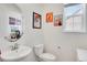 Charming powder room featuring vintage Coca-Cola themed decorations, a pedestal sink, and neutral color palette at 87 Green Fee Cir, Castle Pines, CO 80108