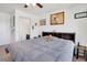Bedroom with neutral carpet, ceiling fan, and large window letting in natural light at 87 Green Fee Cir, Castle Pines, CO 80108