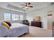 Bright bedroom with tray ceiling, ceiling fan, and a large dresser that enhance the room's decor at 87 Green Fee Cir, Castle Pines, CO 80108