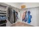 Walk-in closet with ample hanging space and built-in shelving for organized storage at 87 Green Fee Cir, Castle Pines, CO 80108