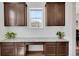Built-in desk with granite countertop, brown cabinets, and a bright window enhances this workspace at 87 Green Fee Cir, Castle Pines, CO 80108