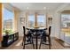 Bright dining area with large windows, a modern table setting, and stylish decor, perfect for gatherings at 87 Green Fee Cir, Castle Pines, CO 80108