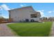 Beautiful backyard with a well-manicured lawn, a covered deck, and ample space for outdoor activities at 87 Green Fee Cir, Castle Pines, CO 80108