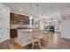 Bright kitchen featuring an island with barstool seating open to the dining area and living room at 87 Green Fee Cir, Castle Pines, CO 80108