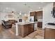 An open kitchen features granite counters, stainless appliances and is open to the living room at 87 Green Fee Cir, Castle Pines, CO 80108