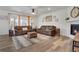 Spacious living room with hardwood floors, plush seating, and a cozy fireplace at 87 Green Fee Cir, Castle Pines, CO 80108