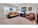 Relaxing living room is furnished with a sofa, armchair, and neutral carpet that creates a cozy atmosphere at 87 Green Fee Cir, Castle Pines, CO 80108
