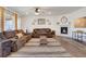 Comfortable living room featuring a fireplace, large windows, and hardwood floors at 87 Green Fee Cir, Castle Pines, CO 80108