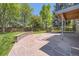 Beautiful backyard with a stone patio, lush green lawn, and a privacy fence at 6338 S Oneida Ct, Centennial, CO 80111