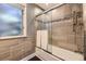Tiled bathroom featuring a bathtub and glass shower doors at 6338 S Oneida Ct, Centennial, CO 80111