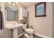 Charming bathroom features pedestal sink, a window, and built in storage cabinet at 6338 S Oneida Ct, Centennial, CO 80111