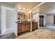 Bathroom with dual sink vanity, granite countertop, framed mirror and mirrored closet at 6338 S Oneida Ct, Centennial, CO 80111