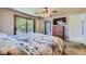 Cozy bedroom with balcony access featuring a ceiling fan and dresser with television at 6338 S Oneida Ct, Centennial, CO 80111