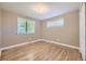 Bedroom featuring hardwood floors, large window and double door closet at 6338 S Oneida Ct, Centennial, CO 80111