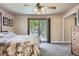 Light-filled bedroom featuring neutral colors, ceiling fan and sliding doors to a balcony at 6338 S Oneida Ct, Centennial, CO 80111