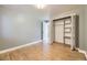 Bedroom with hardwood floors, closet with shelving, and neutral paint color at 6338 S Oneida Ct, Centennial, CO 80111