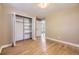 Bedroom featuring hardwood floors and double door closet with shelves at 6338 S Oneida Ct, Centennial, CO 80111