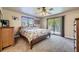 Bright bedroom features large bed, ceiling fan, and sliding glass doors to a deck at 6338 S Oneida Ct, Centennial, CO 80111